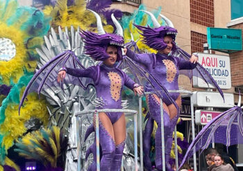 Participantes en el gran desfile de carnaval con trajes coloridos y creativos.