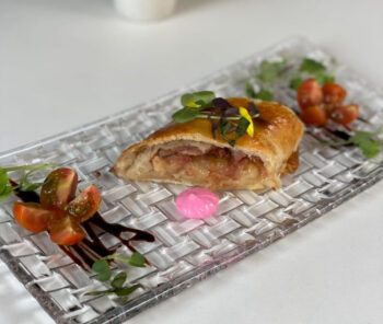 Tapa gourmet presentada en un plato elegante con guarnición