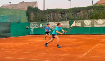 Jugadores de tenis en una cancha de tierra batida durante un torneo