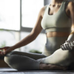 Persona practicando yoga en un ambiente relajante con una mano prostética.